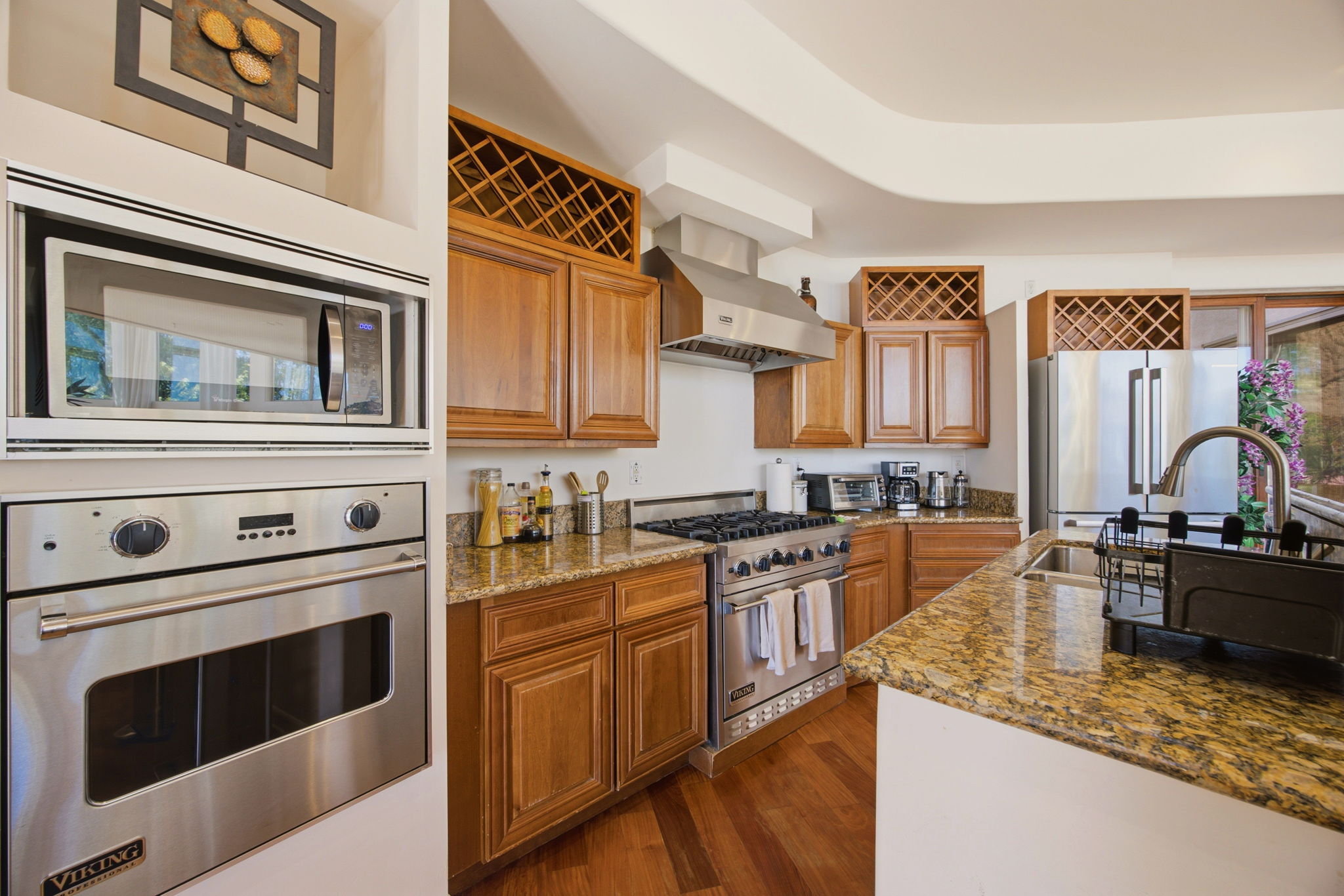 Viking Professional range and wall oven with granite counters and overhead wine storage
